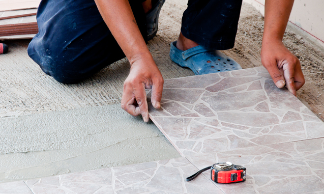 Worker installing tile