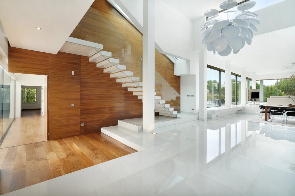 Home interior, modern contemporary furniture room. Access wooden stairs to upper floor.