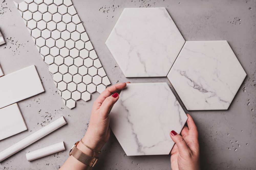 Interior design and home decoration - different shapes of white ceramic and gres tiles. Designer choosing bathroom or kitchen renovation materials. Captured from above (top view, flat lay).